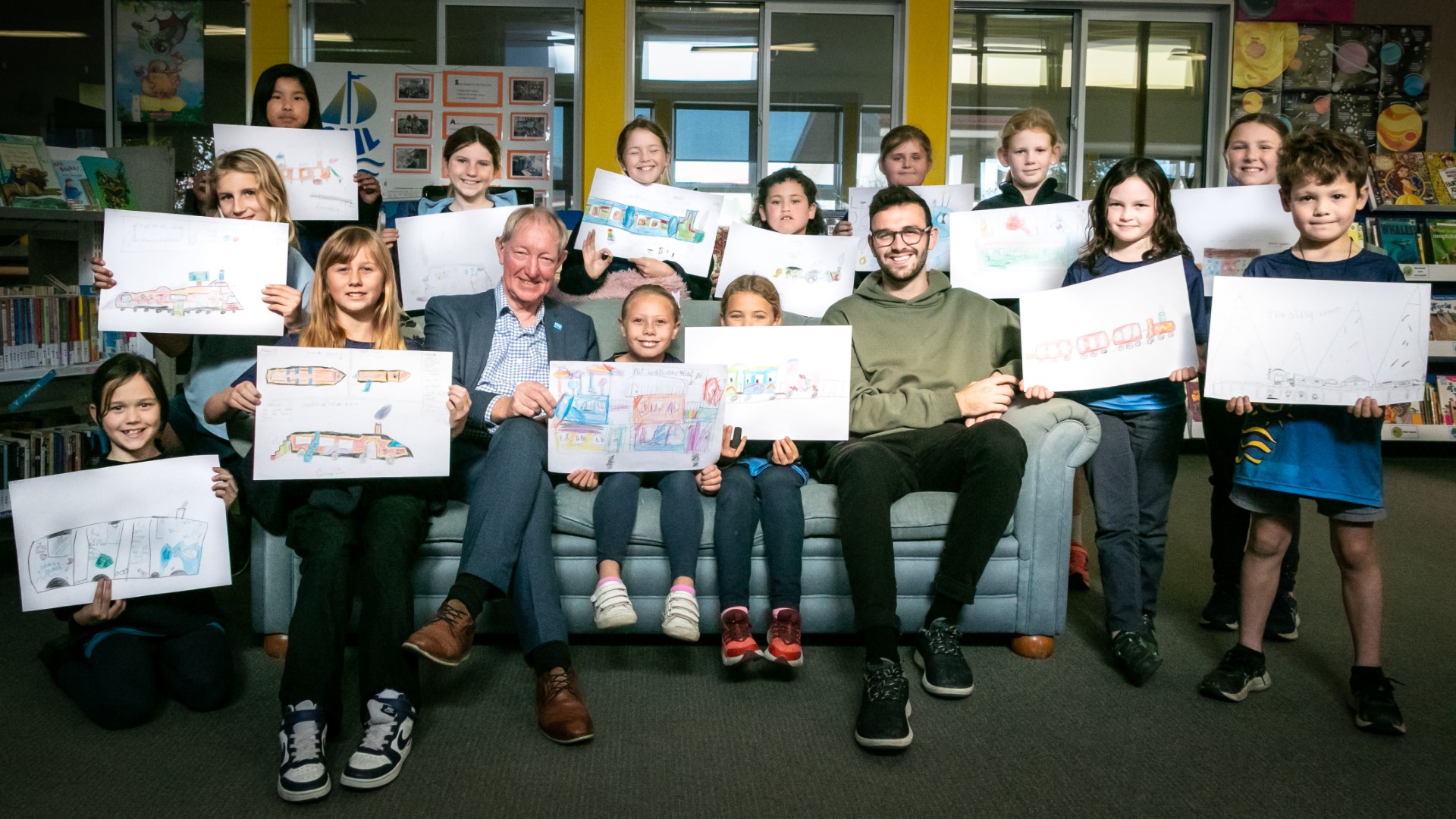 Mayor Nick and Councillor Hodgson with tamariki from Tāhunanui Primary and their train drawings.