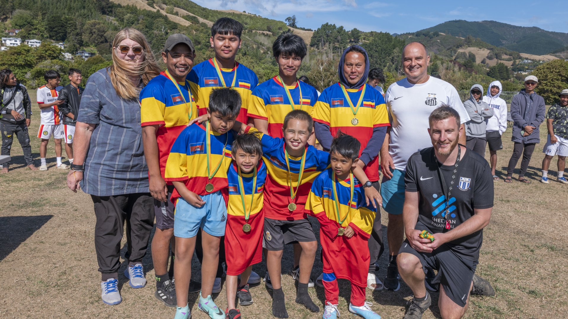 Carol Morgan, board member Multicultural Nelson Tasman (back left) Marcelo Ribas, Health Action Trust (back right) pictured with Bill Huppler (front right) and Team Lil’ Cambo, who won the Spirit of Football Award at the 2024 Multicultural Football Tournament.