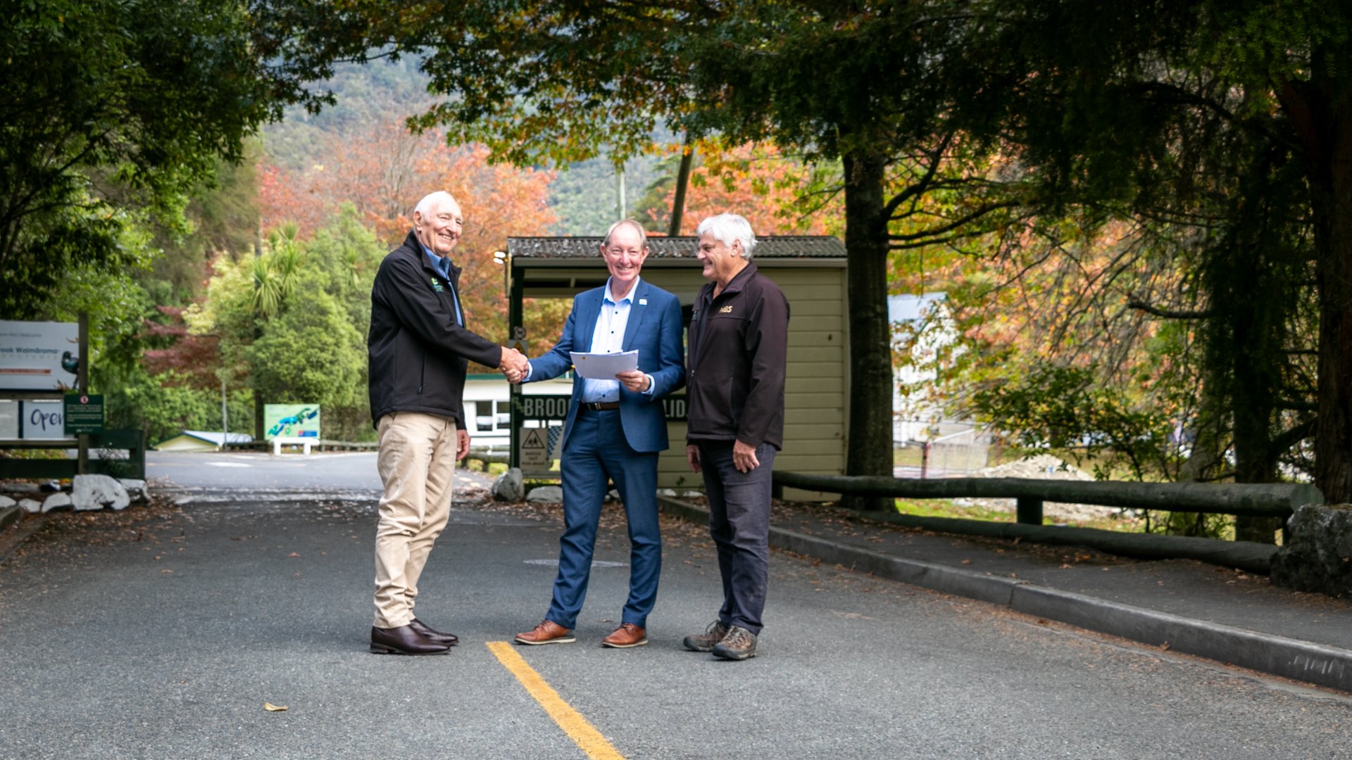 Brook Waimārama Sanctuary Trust Chair Chris Hawkes, left, with Nelson Mayor Nick Smith and Brook Sanctuary Chief Executive Ru Collin, after signing the agreements for the Brook Valley Holiday Park.
