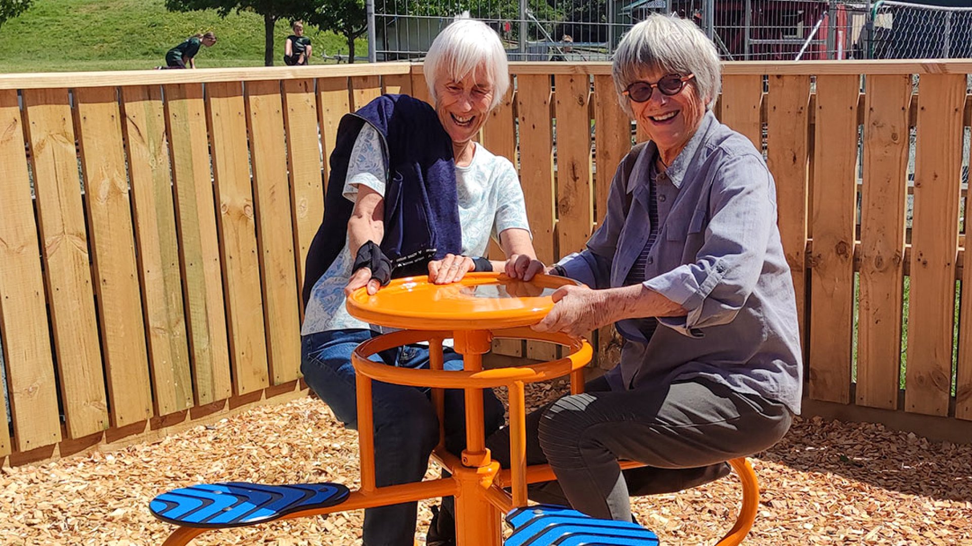 Members of the Friends of Founders try out the upgraded playground equipment. 