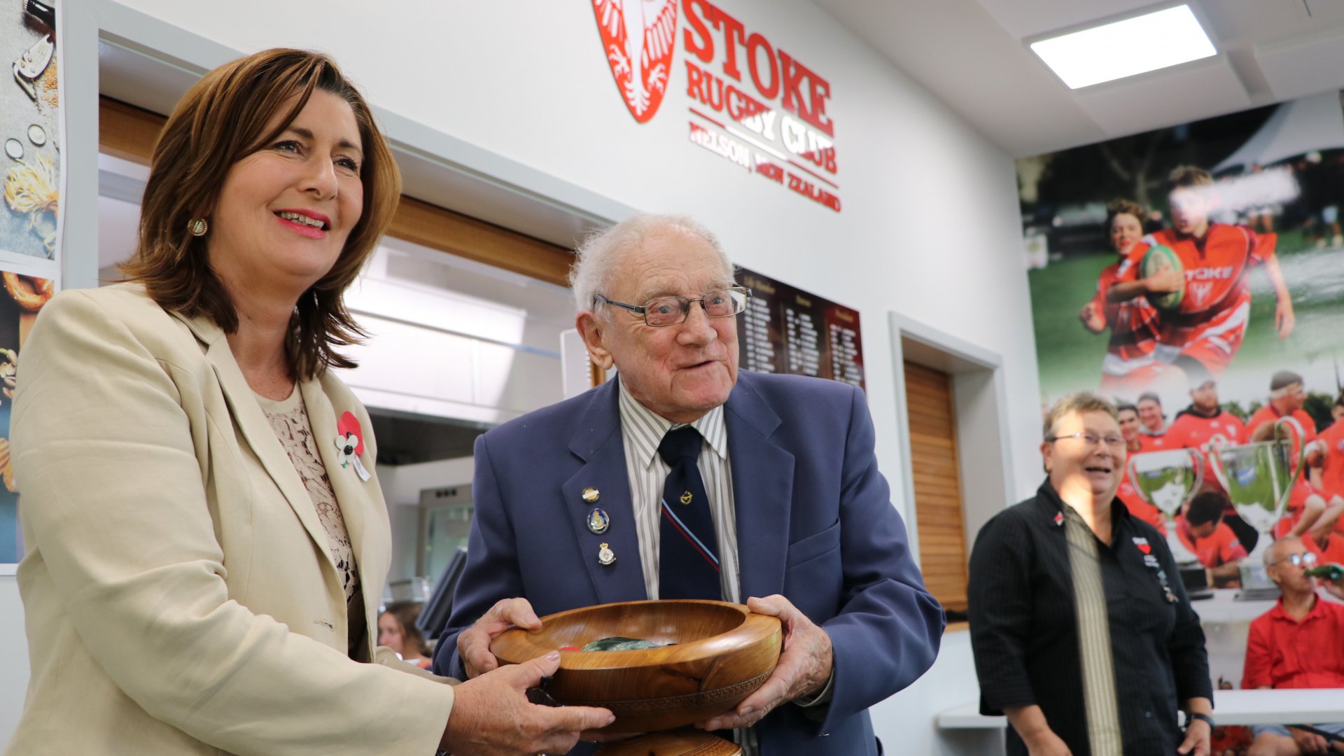 Mayor Rachel Reese presents John Beeching, 97, with the poppy bowl.