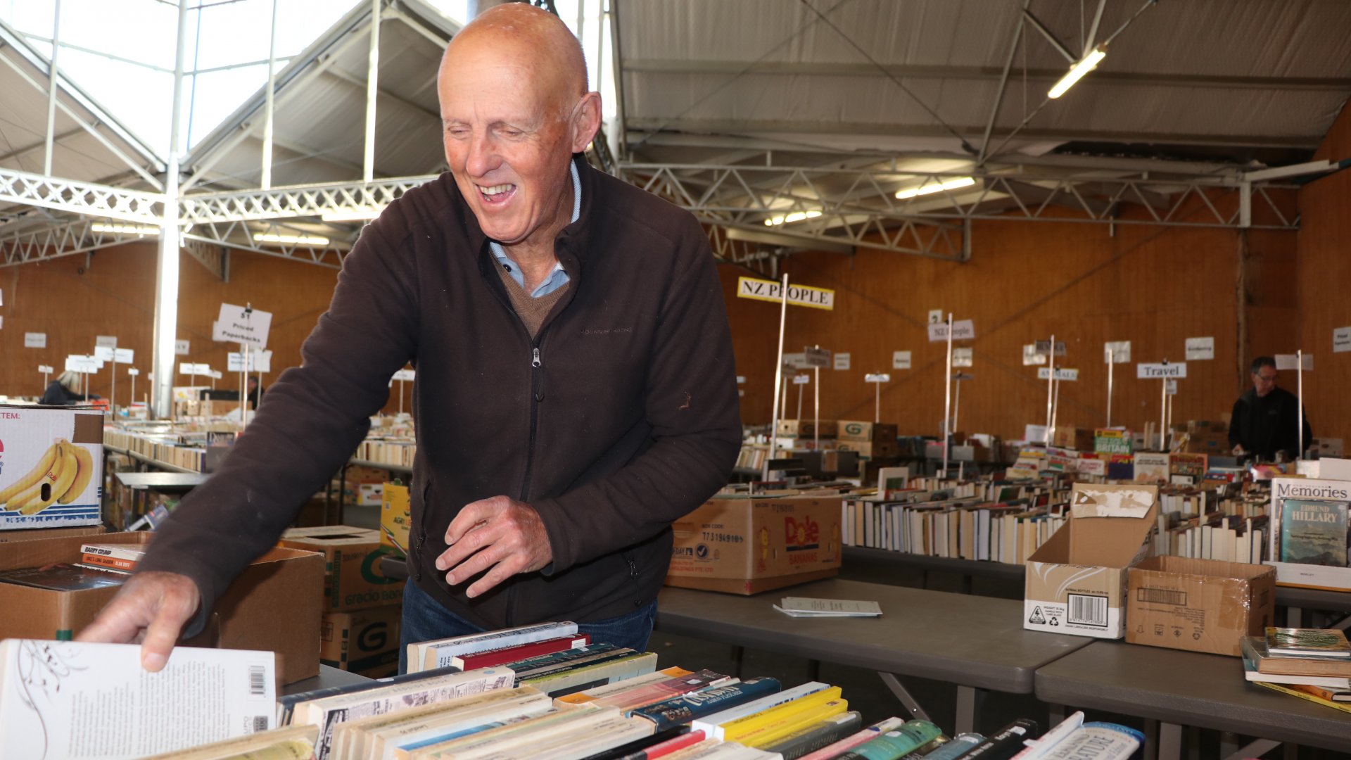 Tom Cumming, volunteer of four years, sorts books in the Energy Centre. 