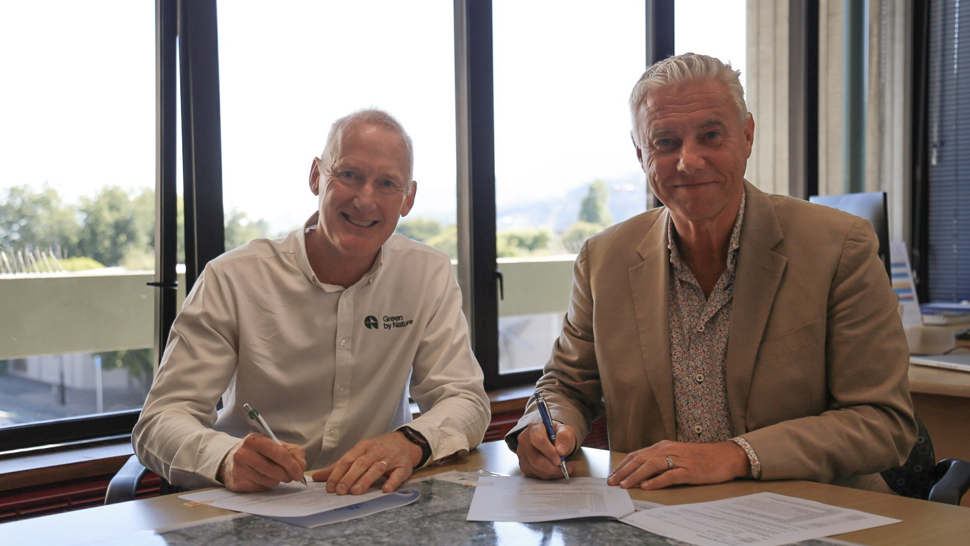 Green by Nature NZ Director Cameron Parr and Nelson City Council Chief Executive Nigel Philpott signing the new open spaces contract. 