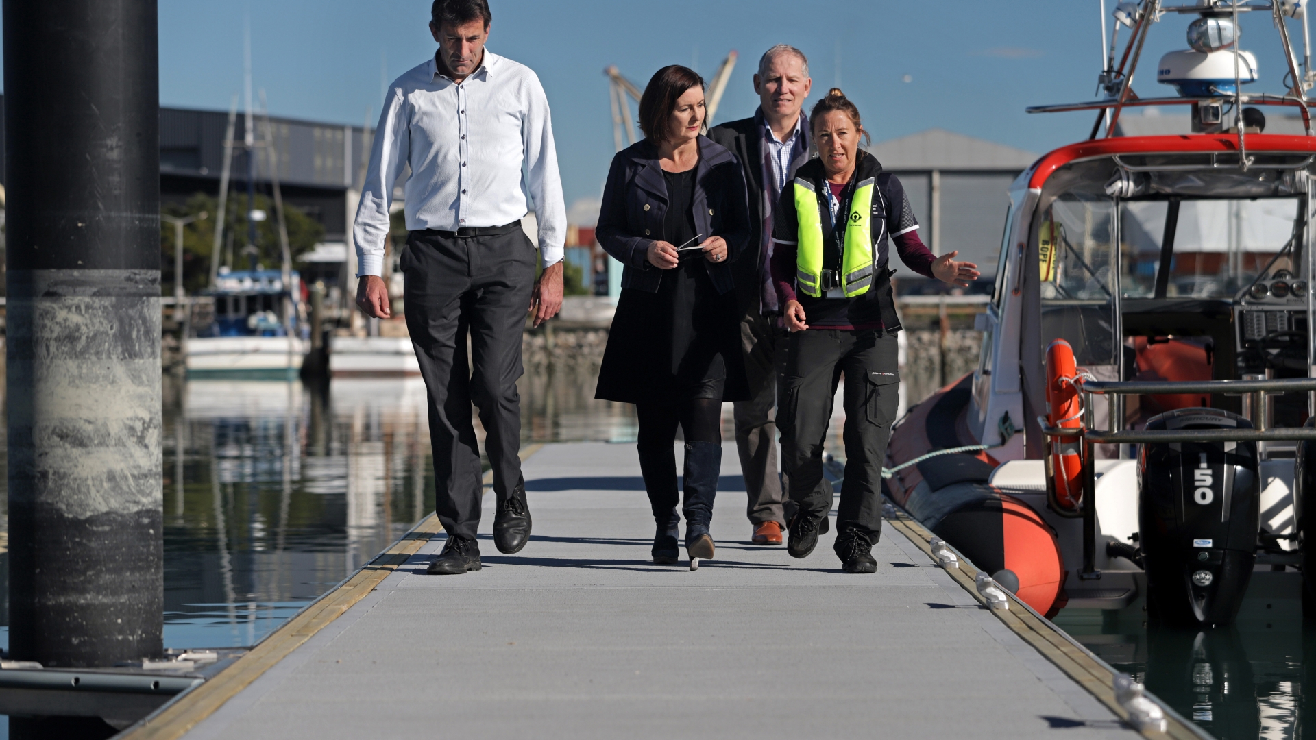 Councillor Tim Skinner, Mayor Rachel Reese, Councillor Bill Dahlberg and Deputy Harbour Master Amanda Kerr walk on the new pontoon.