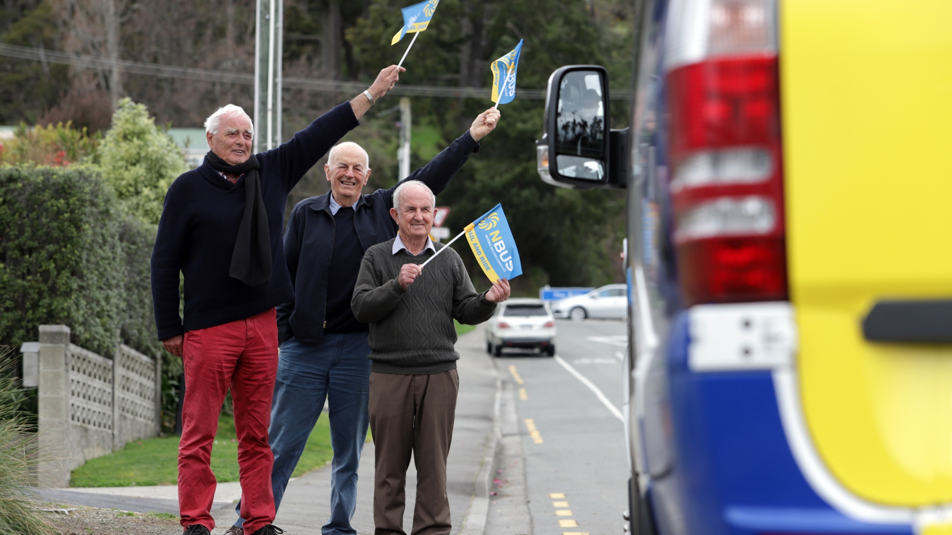 Greypower representatives, Bob Hancock (pictured middle) and George Truman (right) and Deputy Mayor Paul Matheson (left) flag down the bus on the Stoke Loop.