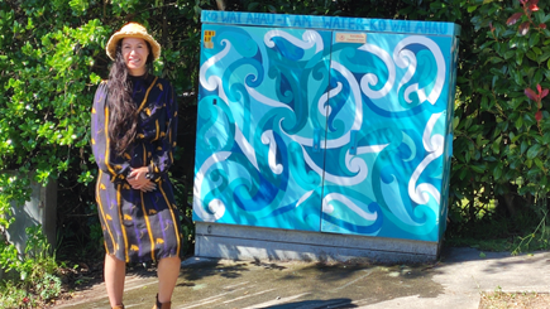 Samara Davis with "Ko Wai Ahau" the cabinet she painted in Paremata Street.