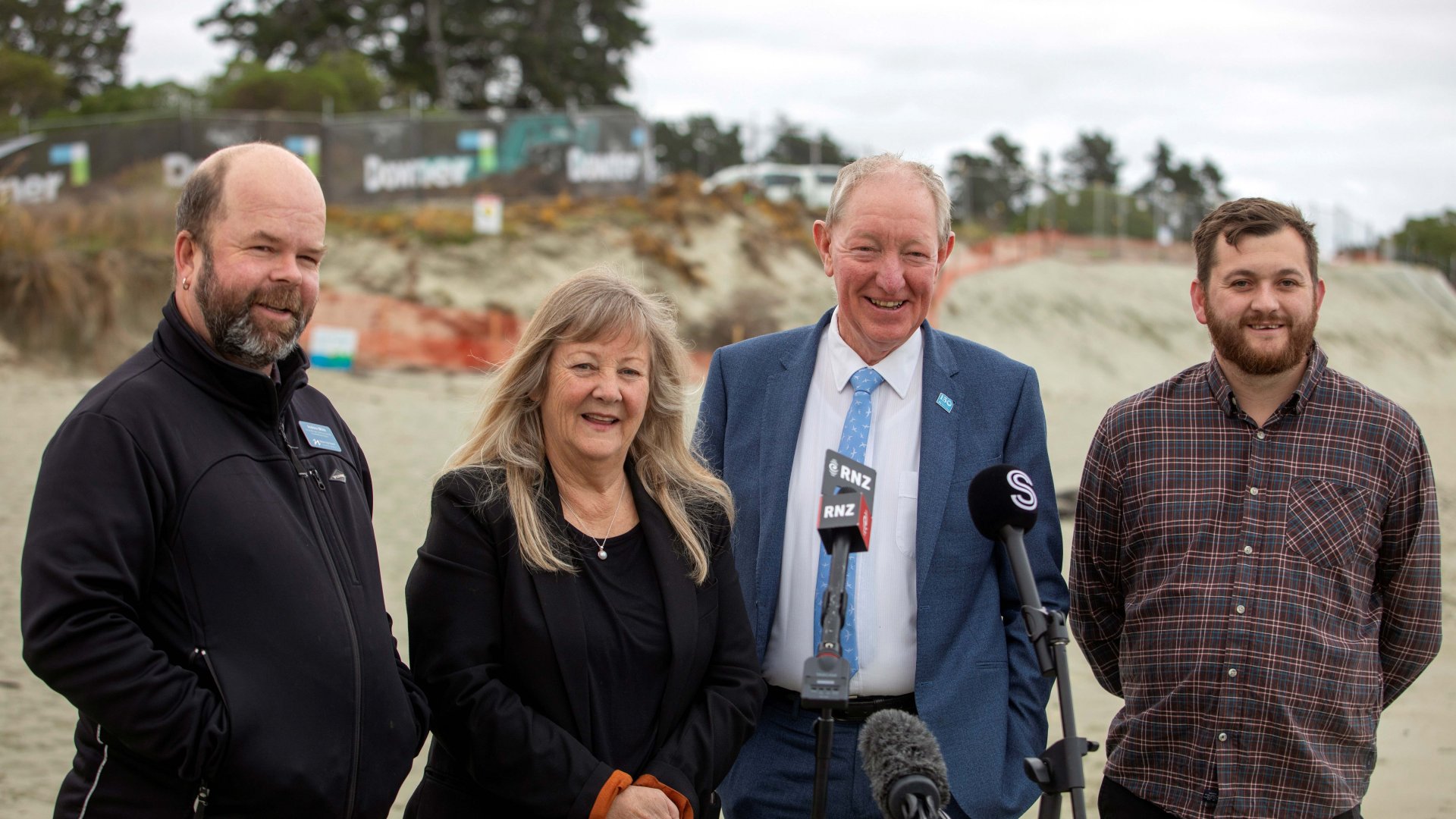 Environment Minister Penny Simmonds announced a $3.44 million contribution to the clean up of the contaminated sawdust at Tāhunanui Beach on Tuesday, the first of the grants from the newly opened Contaminated Sites and Vulnerable Landfills Fund. Pictured: Nelson City Council Group Manager Community Services Andrew White (left), Environment Minister Penny Simmonds, Nelson Mayor Nick Smith and Tāhunanui ward Councillor Campbell Rollo. 