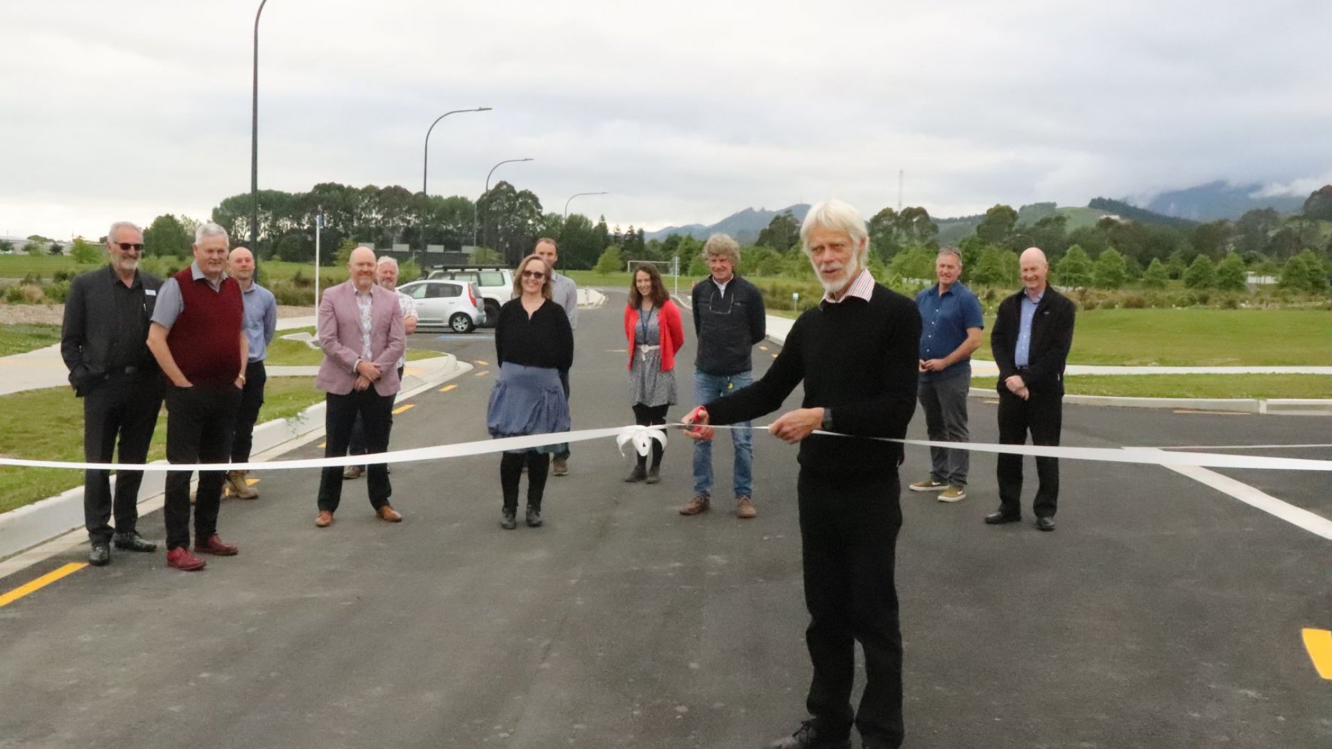 Derek Shaw, Independent Chair of the Saxton Field Committee cuts the ribbon to open the new link road and car park.