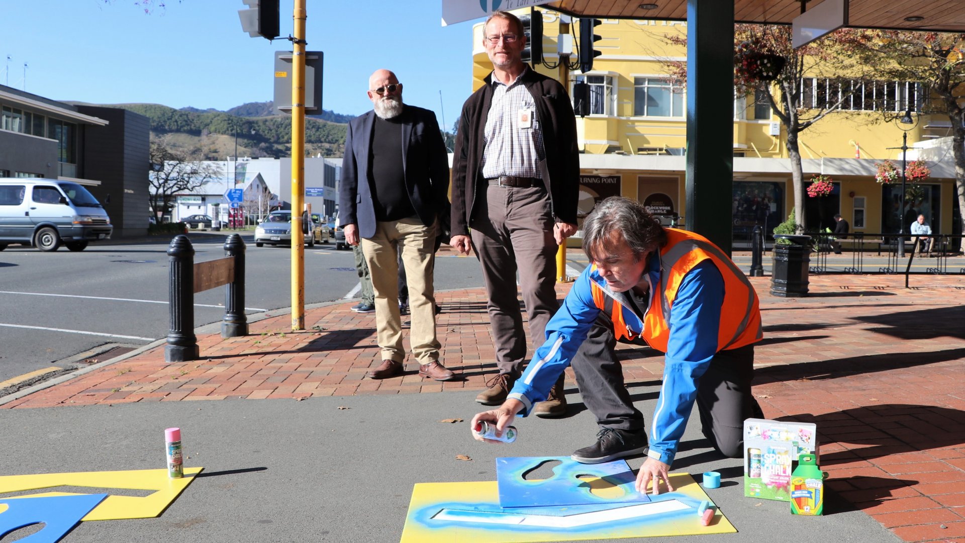 Councillor Pete Rainey (left) and Chief Medical Officer for Nelson Marlborough Health Dr Nick Baker are shown the stencils outside Civic House by City Centre Development Programme Lead Alan Gray. 